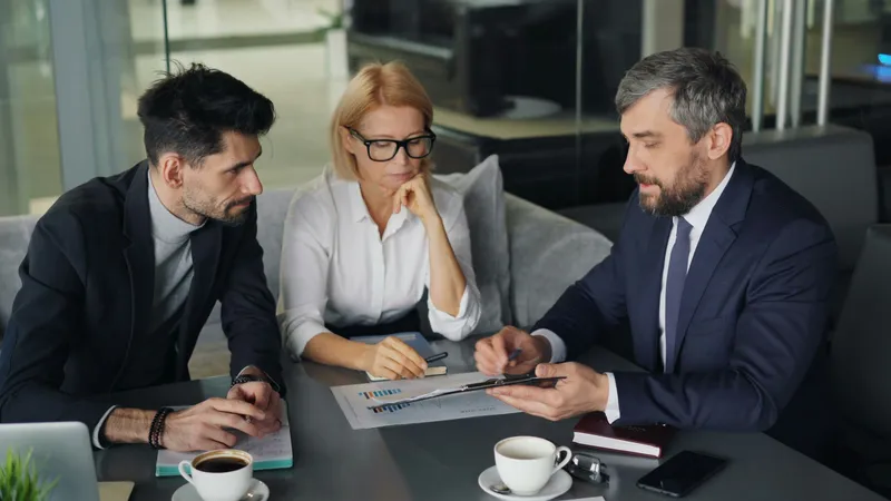 Three people talking at a table